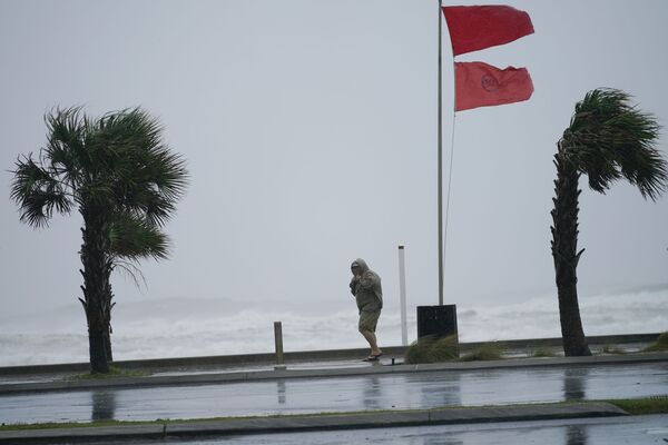 Мужчина во время урагана Салли на набережной города Галф Шорс в штате Алабама - Sputnik Латвия