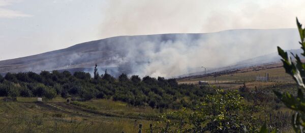 Пожар, возникший в результате обстрела в Нагорном Карабахе Пожар, возникший в результате обстрела в Нагорном Карабахе - Sputnik Latvija