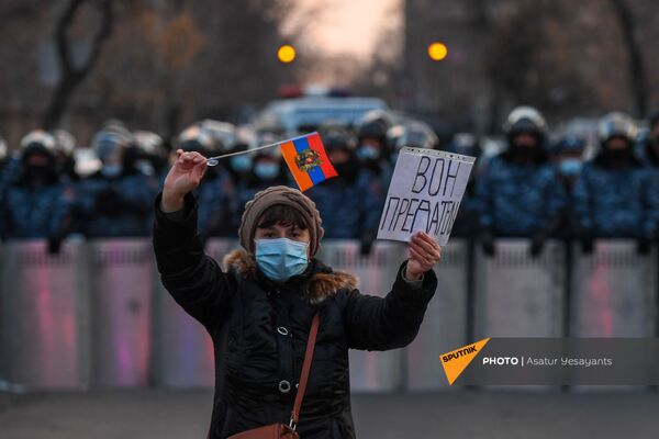 Активистка с плакатом и флагом перед полицейским кордоном во время митинга оппозиции на проспекте Баграмяна перед зданием Национального собрания Армении (3 марта 2021). Еревaн - Sputnik Латвия