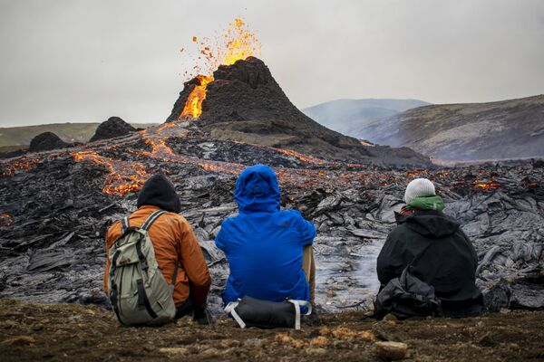 Tūristi vēro vulkāna izvirdumu Reikjanesas pussalā Islandē - Sputnik Latvija