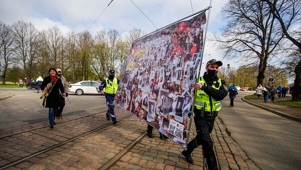 Полицейские помогают нести плакат, посвященный Бессмертному полку - Sputnik Латвия