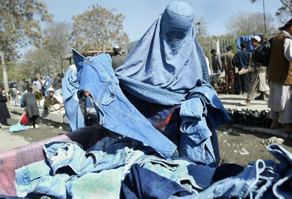 Афганская женщина выбирает голубые джинсы на улице Кабула, Афганистан, 2003 год. - Sputnik Латвия