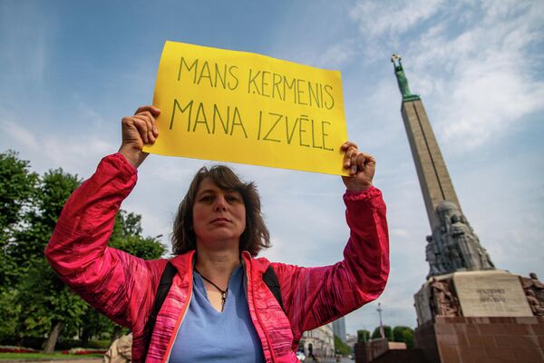 На акцию протеста против обязательной вакцинации к памятнику Свободы люди пришли подготовленными. - Sputnik Латвия