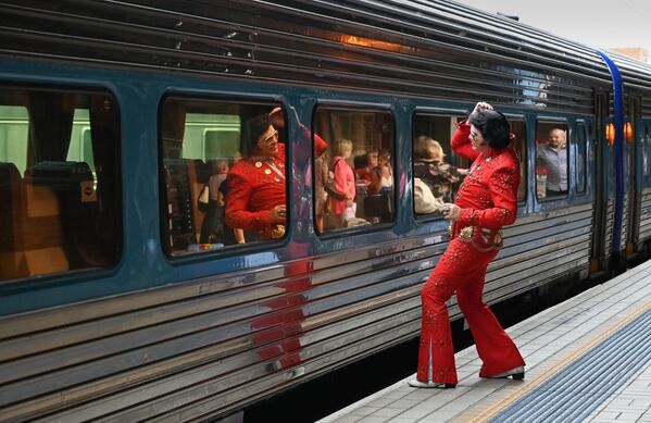 Elvisa fans spoguļojas vilciena logā pirms iekāpšanas vilcienā uz &quot;Parkes Elvis&quot; festivālu Sidnejā 2019. gada 10. janvārī. &quot;Parkes Elvis&quot; festivāls ir ikgadējs pasākums, veltīts Elvisa Preslija mūzikai un dzīvei - Sputnik Latvija