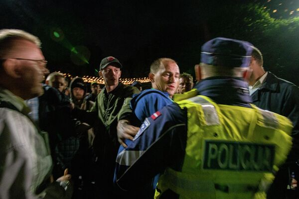 Полицейский разговаривает с протестующими на акции в Риге - Sputnik Латвия