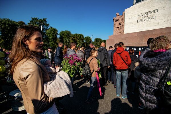 Женщина с грудным ребенком на митинге протеста у памятника Свободы - Sputnik Латвия