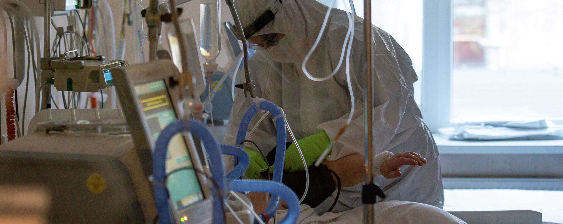 Медицинский работник у кровати пациента с COVID-19 в Центре легочных заболеваний и туберкулеза в Даугавпилсе - Sputnik Латвия, 1920, 04.02.2024