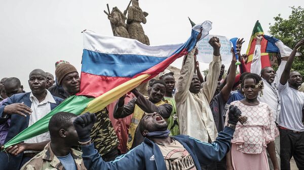 Протестующие размахивают национальными и российскими флагами в столице Мали на демонстрации против французского влияния, 27 мая 2021 года - Sputnik Латвия
