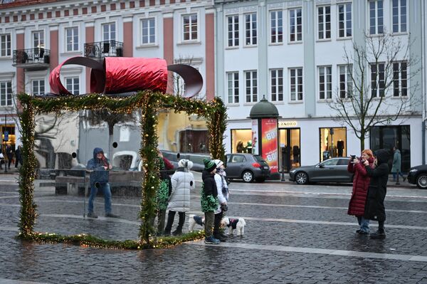 На фото: жители Вильнюса фотографируются на фоне огромной &quot;подарочной коробки&quot;. - Sputnik Латвия