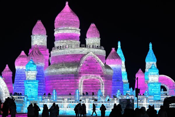 Фестиваль снежных и ледяных скульптур проводится с 1963 года.На фото: люди посещают Харбинский мир льда и снега в Харбине. - Sputnik Латвия