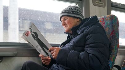 Латвиец читает журнал в поезде