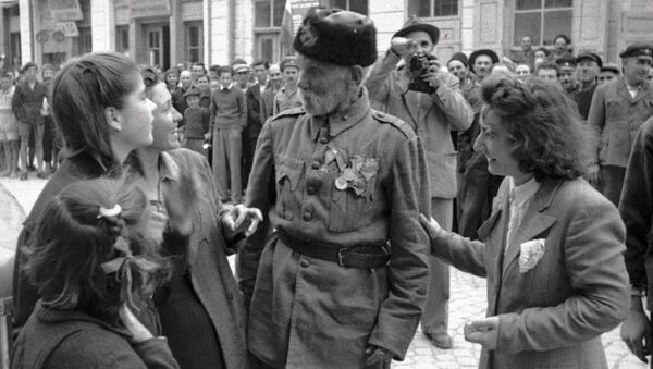 Ветеран турецкой войны беседует с девушками, в освобожденном войсками РККА от фашистов, болгарском городе, 1944 год - Sputnik Latvija