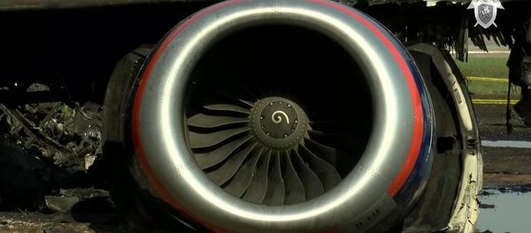 Фрагмент обгоревшего самолета компании Аэрофлот Sukhoi Superjet-100 на летном поле в аэропорту Шереметьево - Sputnik Латвия
