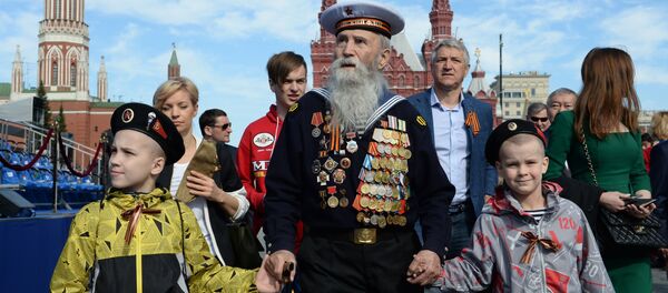 Ветеран с детьми перед началом военного парада в ознаменование 70-летия Победы в Великой Отечественной войне 1941-1945 годов Ветеран с детьми перед началом военного парада в ознаменование 70-летия Победы в Великой Отечественной войне 1941-1945 годов - Sputnik Latvija
