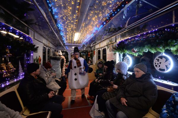 Пассажиры рождественского вагона в составе новогоднего поезда Московского метрополитена - Sputnik Латвия