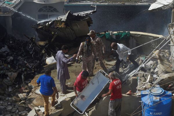 Спасатели на месте крушения самолета Пакистанских авиалиний в Карачи - Sputnik Латвия