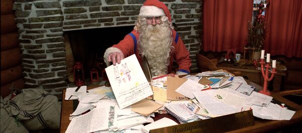 Санта Клаус в своей резиденции разбирает рождественскую почту - Sputnik Латвия