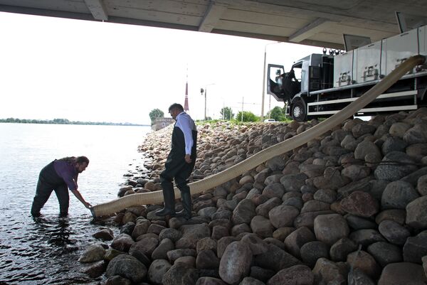 Руководство Департамента жилья и среды Рижской думы запустило в Даугаву 3 тысячи мальков озерного сига - Sputnik Латвия