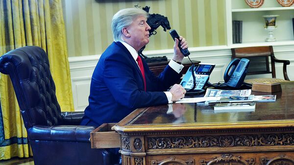Президент США Дональд Трамп говорит по телефону в овальном кабинете - Sputnik Latvija