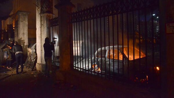 Оператор одного из грузинских телеканалов снимает сожженные в ходе беспорядков в Батуми машины - Sputnik Латвия