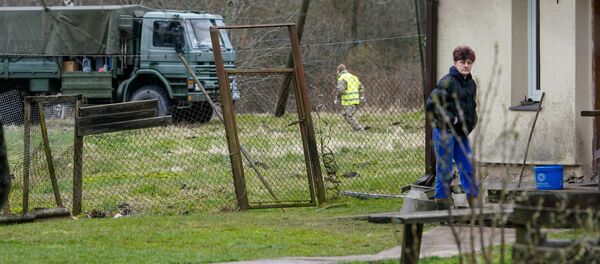 Мирные жители с интересом наблюдают за военной активностью возле их дома Мирные жители с интересом наблюдают за военной активностью возле их дома - Sputnik Latvija