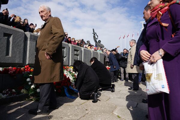 Жители Риги возлагают цветы к памятнику Освободителям - Sputnik Латвия