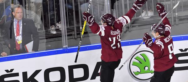 Игрок сборной Латвии Теодор Блюгерс (слева) радуется заброшенной шайбе в матче группового этапа чемпионата мира по хоккею 2017 - Sputnik Латвия