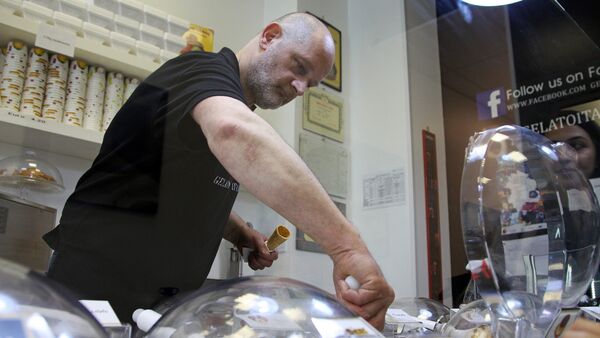 Хозяин кафе Gelato Italia итальянец Дарио Бони за прилавком своего уютного кафе - Sputnik Латвия