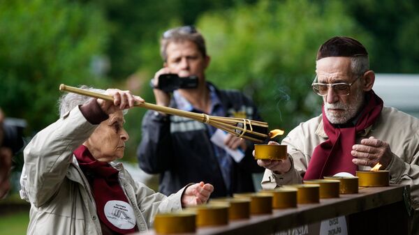 Тея Брайнина зажигает поминальную свечу в память о жертвах Рижского гетто - Sputnik Латвия