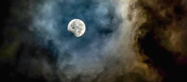 Луна, обрамленная пеплом от вулкана Маунт Синабунг, видна во время частичного лунного затмения в провинции Северная Суматра в Индонезии Луна, обрамленная пеплом от вулкана Маунт Синабунг, видна во время частичного лунного затмения в провинции Северная Суматра в Индонезии - Sputnik Latvija