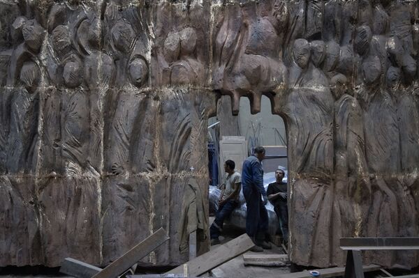 Рабочие готовятся закрепить элементы конструкции монумента Стена скорби перед началом его транспортировки к месту установки в Москве Рабочие готовятся закрепить элементы конструкции монумента Стена скорби перед началом его транспортировки к месту установки в Москве - Sputnik Латвия
