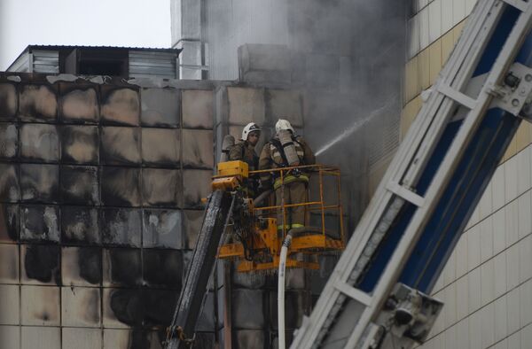 Сотрудники пожарной охраны МЧС во время тушения пожара в торговом центре Зимняя вишня в Кемерове - Sputnik Латвия