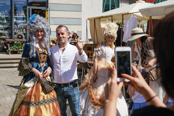 Туристы фотографируются с участниками фестиваля Майский граф - 2018 в Риге - Sputnik Латвия